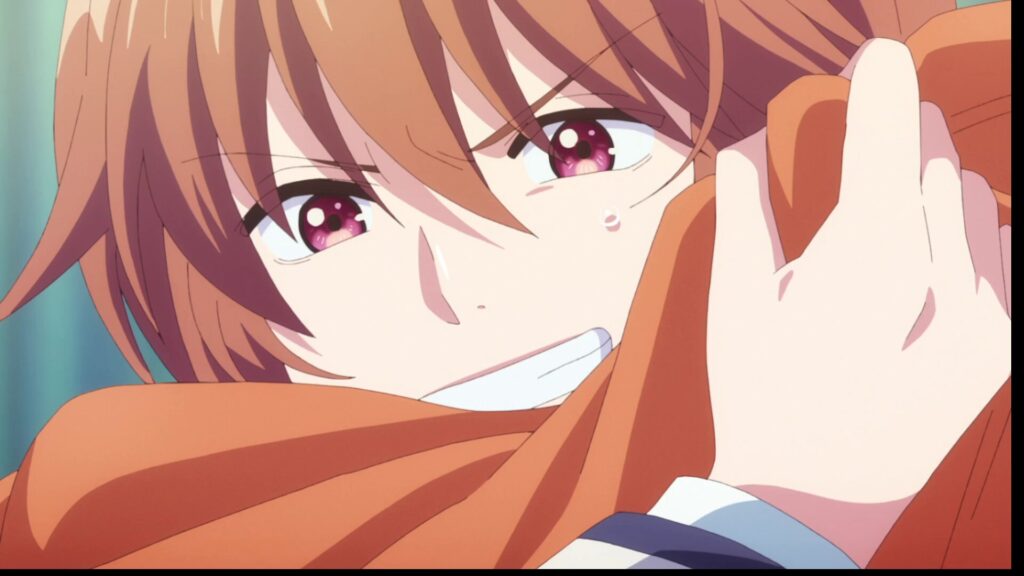 涙を浮かべた赤髪のアニメキャラクターがオレンジ色の布を強く抱きしめているシーン