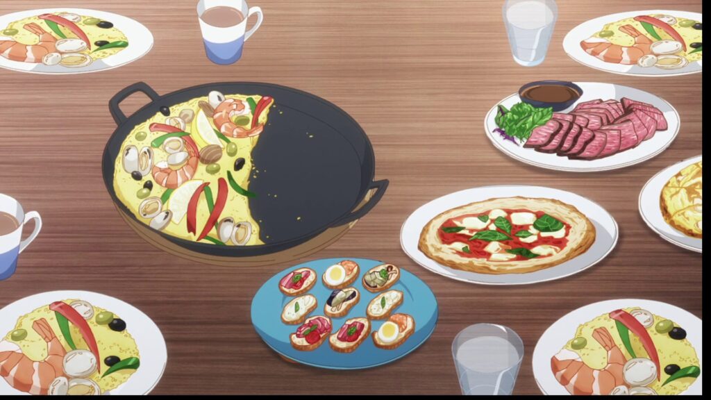 『お隣の天使様』第2期 第3話。藤宮周の両親が真昼を歓迎するために用意した、豪華な手料理の数々。大鍋のパエリア、ローストビーフ、マルゲリータピザ、彩り豊かなカナッペなどが並ぶ木目調のテーブル。家族の温もりと「食」を通じた心の交流を象徴するシーンカット。